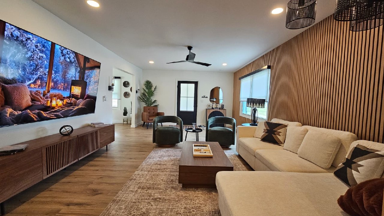 Modern mountain home living room with 85-inch TV and wood slat accent wall